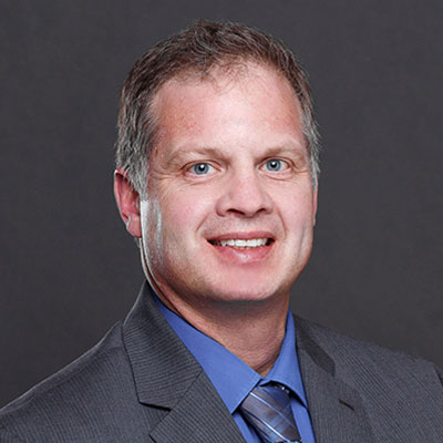 Portrait of Stephen Boehm smiling at the camera.