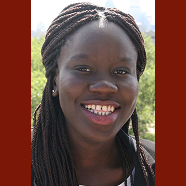 Portrait of Elaine Kouame smiling at the camera.