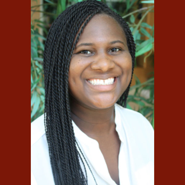 Portrait of Jasmyn Sanders smiling at the camera.