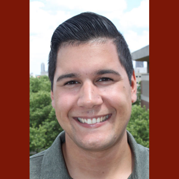 Portrait of Robert Altamirano smiling at the camera.