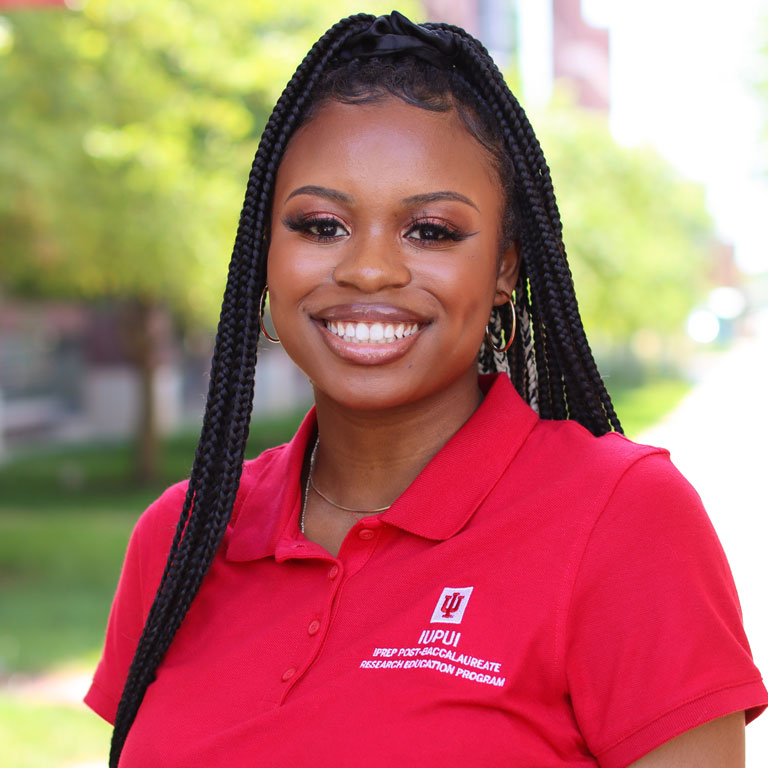 Portrait photo of Kennedy Pope smiling at the camera.