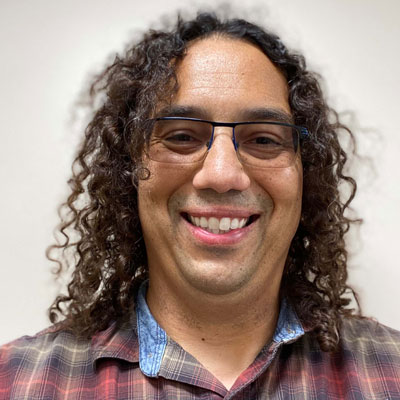 Portrait of Anthony J. (A.J.) Baucum II smiling at the camera.